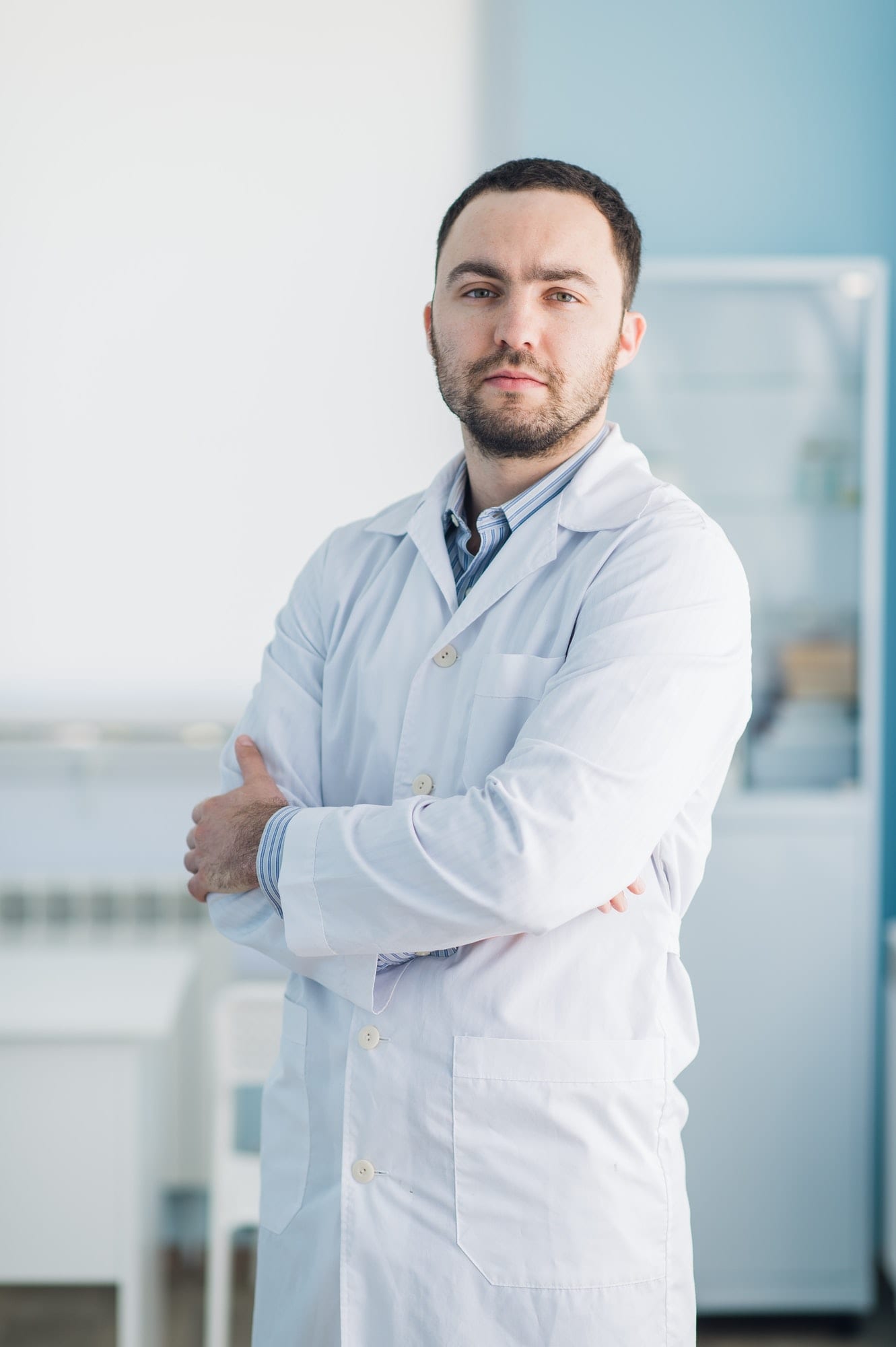 Young handsome doctor indoors at hospital office