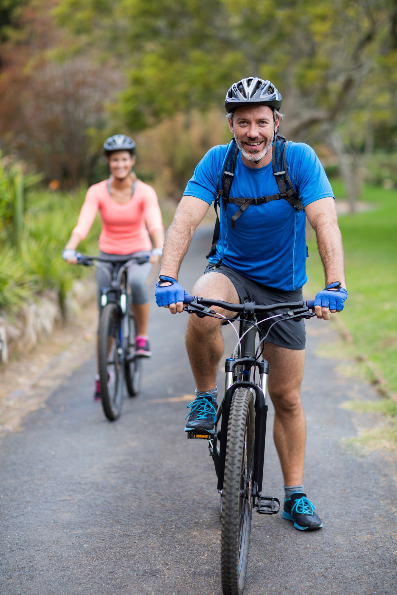 Athletic couple cycling on the road